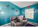Inviting living room with a reclining loveseat, bright blue walls, and natural light from the window at 4349 River Ridge Dr, Leesburg, FL 34748