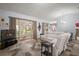 Bright and airy living area with sliding glass doors leading to the screened porch and a large sectional couch at 4349 River Ridge Dr, Leesburg, FL 34748