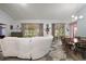 Bright living room with large sliding doors opening to a screened porch and a spacious seating area with a dining table at 4349 River Ridge Dr, Leesburg, FL 34748