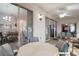 Covered patio area with outdoor seating, ceiling fan, and views of the home's interior through sliding glass doors at 4349 River Ridge Dr, Leesburg, FL 34748