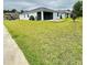 Backyard with a well-manicured lawn, spacious patio, and covered lanai at 496 Brunswick Dr, Davenport, FL 33837
