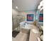 Bathroom featuring a walk-in shower, a relaxing tub, and elegant fixtures at 496 Brunswick Dr, Davenport, FL 33837