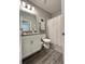 Bright bathroom with modern vanity, tile floors, and shower with white curtain at 496 Brunswick Dr, Davenport, FL 33837