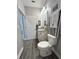 Charming bathroom featuring wood-look tile, stylish decor and ample lighting at 496 Brunswick Dr, Davenport, FL 33837