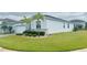 Beautiful property showcases lush green grass, stone accents, and well-placed palm trees in a serene setting at 496 Brunswick Dr, Davenport, FL 33837