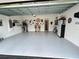 Garage with shelving and work space, offering ample room for storage and projects at 496 Brunswick Dr, Davenport, FL 33837