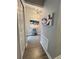 Hallway features decorative lighting, artwork, and stylish floors at 496 Brunswick Dr, Davenport, FL 33837