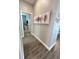 Hallway featuring wood-look tile flooring and decorative wall art at 496 Brunswick Dr, Davenport, FL 33837