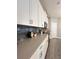 Charming kitchen with gray counters, subway tile backsplash, and ample white cabinet space at 496 Brunswick Dr, Davenport, FL 33837
