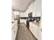 Well-appointed kitchen featuring modern appliances, gray countertops, and sleek white cabinets at 496 Brunswick Dr, Davenport, FL 33837