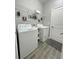 Functional laundry room with washer, dryer, shelving, and ample space for organization at 496 Brunswick Dr, Davenport, FL 33837