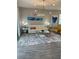 Bright and airy living room boasts a white sofa, chic decor, and wood-look tile flooring at 496 Brunswick Dr, Davenport, FL 33837