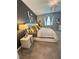 Stylish main bedroom showcasing neutral colors, a nightstand, and decorative lamps and wall art at 496 Brunswick Dr, Davenport, FL 33837