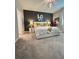 Bright main bedroom featuring contemporary decor, plush carpet, and a modern lighting fixture at 496 Brunswick Dr, Davenport, FL 33837