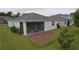 Backyard featuring a screened-in patio and brick paver area, perfect for outdoor entertaining and relaxation at 496 Brunswick Dr, Davenport, FL 33837