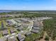 A beautiful aerial view of a residential community showcasing the well-maintained homes and landscaped surroundings with a lake in the background at 524 Avila Pl, Howey In The Hills, FL 34737