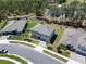 Aerial view of three homes in a residential neighborhood, featuring well-manicured lawns at 524 Avila Pl, Howey In The Hills, FL 34737
