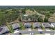 Aerial view of homes in a community surrounded by green space and roads, showcasing the neighborhood layout at 524 Avila Pl, Howey In The Hills, FL 34737