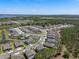 An aerial view captures a residential community with a blend of modern homes and natural landscapes near bodies of water at 524 Avila Pl, Howey In The Hills, FL 34737