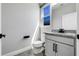 Compact bathroom featuring a modern vanity, toilet, and window at 524 Avila Pl, Howey In The Hills, FL 34737