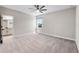 Bright bedroom featuring carpet, neutral walls, large window, and an ensuite bathroom at 524 Avila Pl, Howey In The Hills, FL 34737