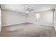 Spacious bedroom featuring carpet, neutral walls, ceiling fan, and ensuite bathroom at 524 Avila Pl, Howey In The Hills, FL 34737