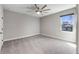 Neutral bedroom with a ceiling fan and a window providing natural light at 524 Avila Pl, Howey In The Hills, FL 34737