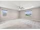 Spacious bedroom featuring carpet, neutral walls, and large windows for lots of natural light at 524 Avila Pl, Howey In The Hills, FL 34737