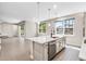 Modern kitchen featuring white cabinets, a large island, stainless steel appliances, and an open floor plan at 524 Avila Pl, Howey In The Hills, FL 34737