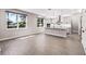 Bright open kitchen with gray cabinets, an island, tile floors, and lots of natural light at 524 Avila Pl, Howey In The Hills, FL 34737
