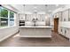 Modern kitchen with gray cabinets, a large island, stainless steel appliances, and plenty of natural light at 524 Avila Pl, Howey In The Hills, FL 34737
