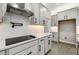 Modern kitchen features sleek countertops, a stainless steel range hood, and gray cabinets at 524 Avila Pl, Howey In The Hills, FL 34737
