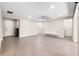 Large living room with multiple entry points and wood-look flooring at 524 Avila Pl, Howey In The Hills, FL 34737