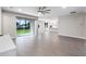 Spacious living room featuring modern gray floors, lots of natural light, and an open floor plan at 524 Avila Pl, Howey In The Hills, FL 34737