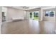 Inviting living room with sliding glass doors to the backyard and wood-look tile flooring at 524 Avila Pl, Howey In The Hills, FL 34737