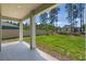 Covered patio overlooking a green backyard with tall trees and a privacy fence at 524 Avila Pl, Howey In The Hills, FL 34737