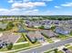 Aerial view of community with ponds and well-kept landscaping at 533 Avila Pl, Howey In The Hills, FL 34737