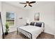 Comfortable bedroom with a black metal bed frame, desk, and large window with blinds at 533 Avila Pl, Howey In The Hills, FL 34737