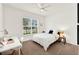 Cozy bedroom with a white bed, desk, and a large window overlooking the street at 533 Avila Pl, Howey In The Hills, FL 34737