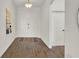 Bright foyer features ceramic wood-look tile flooring, with double front doors and adjacent closet at 533 Avila Pl, Howey In The Hills, FL 34737