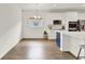Modern kitchen featuring white cabinets, stainless steel appliances, and a blue kitchen island at 533 Avila Pl, Howey In The Hills, FL 34737