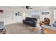 Spacious living room with ceiling fan, carpeted floor, and view of backyard at 533 Avila Pl, Howey In The Hills, FL 34737