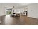 Open living room with tile floors, natural light, and seamless access to the kitchen at 533 Avila Pl, Howey In The Hills, FL 34737