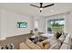Bright living room boasts tile floors, a neutral color palette, and sliding glass door to lanai at 533 Avila Pl, Howey In The Hills, FL 34737