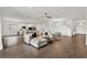 Bright living room boasts tile floors, a neutral color palette, and seamless access to the kitchen at 533 Avila Pl, Howey In The Hills, FL 34737