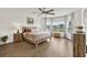 Main bedroom with a wooden bed frame, ceiling fan, and a large bay window with a view at 533 Avila Pl, Howey In The Hills, FL 34737