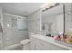 This bathroom features a glass enclosed shower and a marble top vanity at 54 Andora Ct, Kissimmee, FL 34758