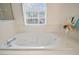 Relax in this bathroom's large soaking tub with jacuzzi jets at 54 Andora Ct, Kissimmee, FL 34758