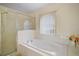 This bathroom boasts a large soaking tub with jacuzzi jets and shower at 54 Andora Ct, Kissimmee, FL 34758