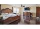 This primary bedroom boasts dark hardwood floors and a large poster bed at 54 Andora Ct, Kissimmee, FL 34758